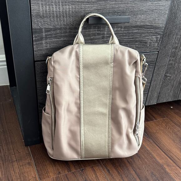 Handbags - Neutral Taupe Woman’s Backpack with Metallic Accent and many zipper pockets.